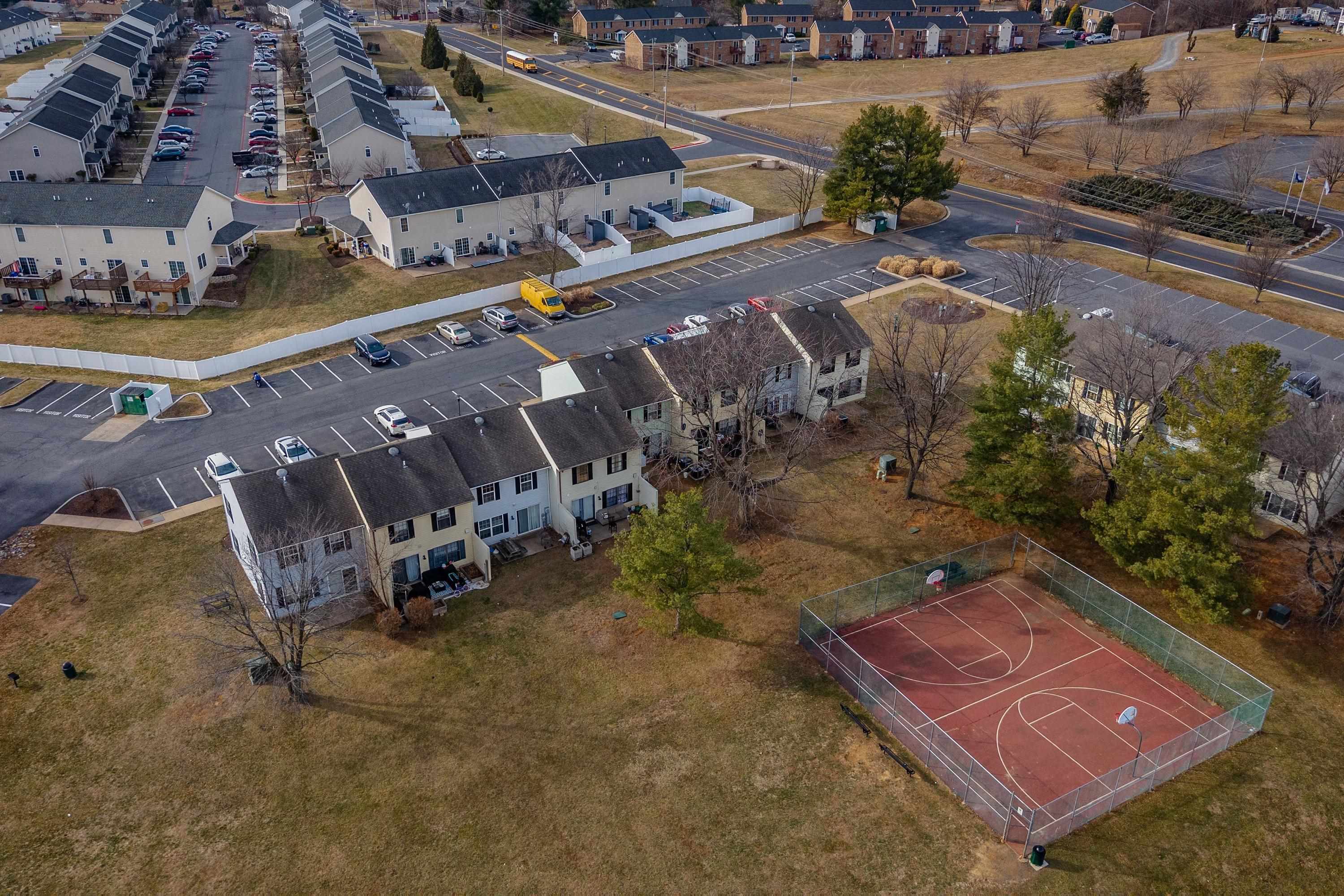 1211 Old Furnace Road Harrisonburg, VA 22802 - Photo 34 of 55 The aerial photo highlights the townhouse location within the Madison Manor neighborhood, the abundance of parking spaces, and the convenient location within the city of Harrisonburg.