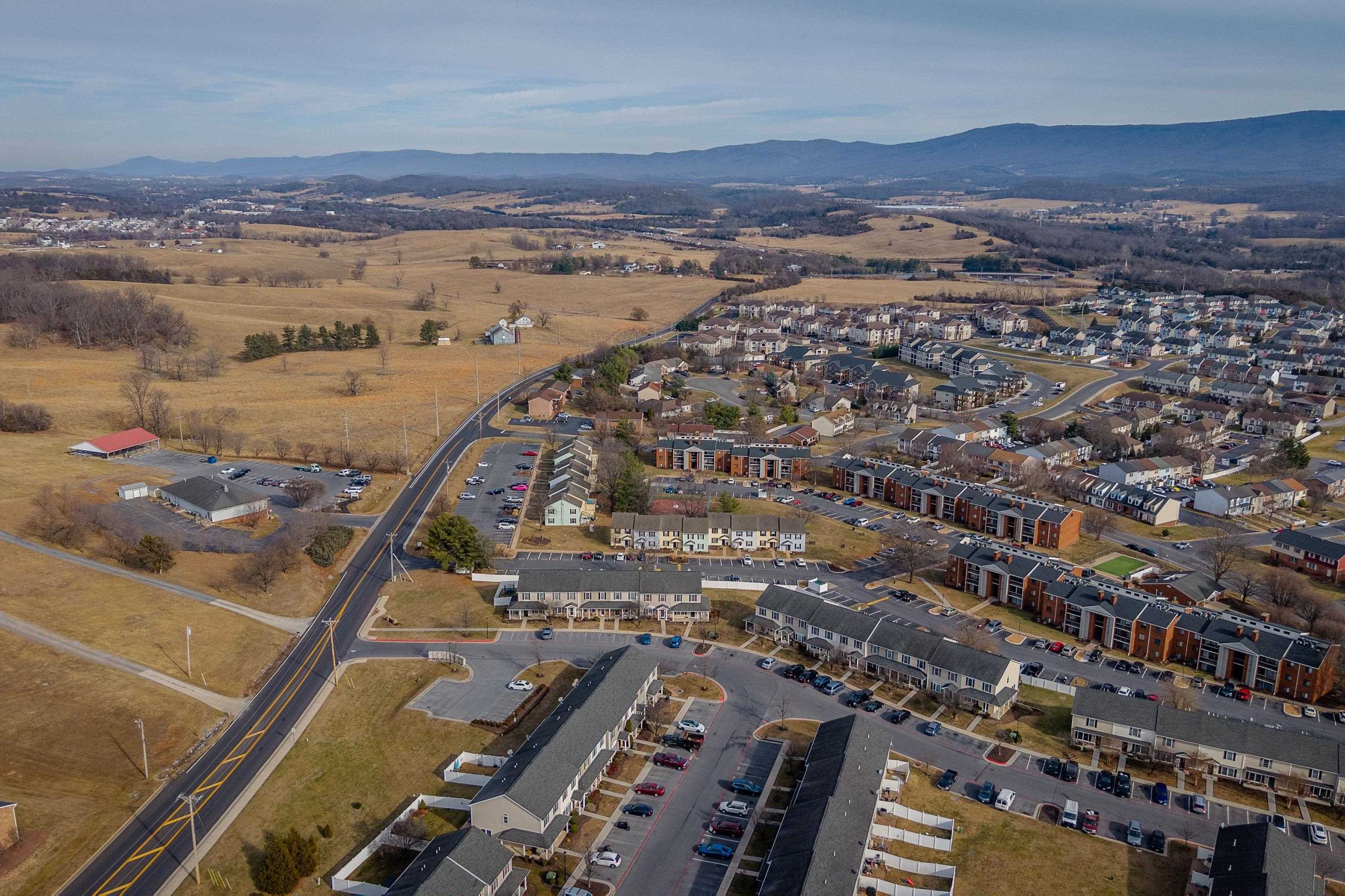 1211 Old Furnace Road Harrisonburg, VA 22802 - Photo 38 of 55 The aerial photo highlights the townhouse location within the Madison Manor neighborhood, the abundance of parking spaces, and the convenient location within the city of Harrisonburg.