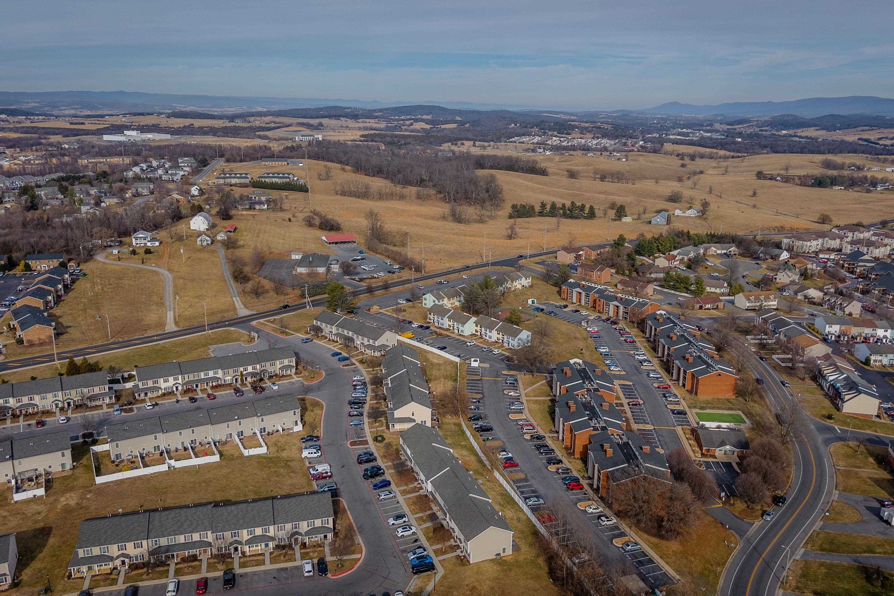 1211 Old Furnace Road Harrisonburg, VA 22802 - Photo 39 of 55 The aerial photo highlights the townhouse location within the Madison Manor neighborhood, the abundance of parking spaces, and the convenient location within the city of Harrisonburg.