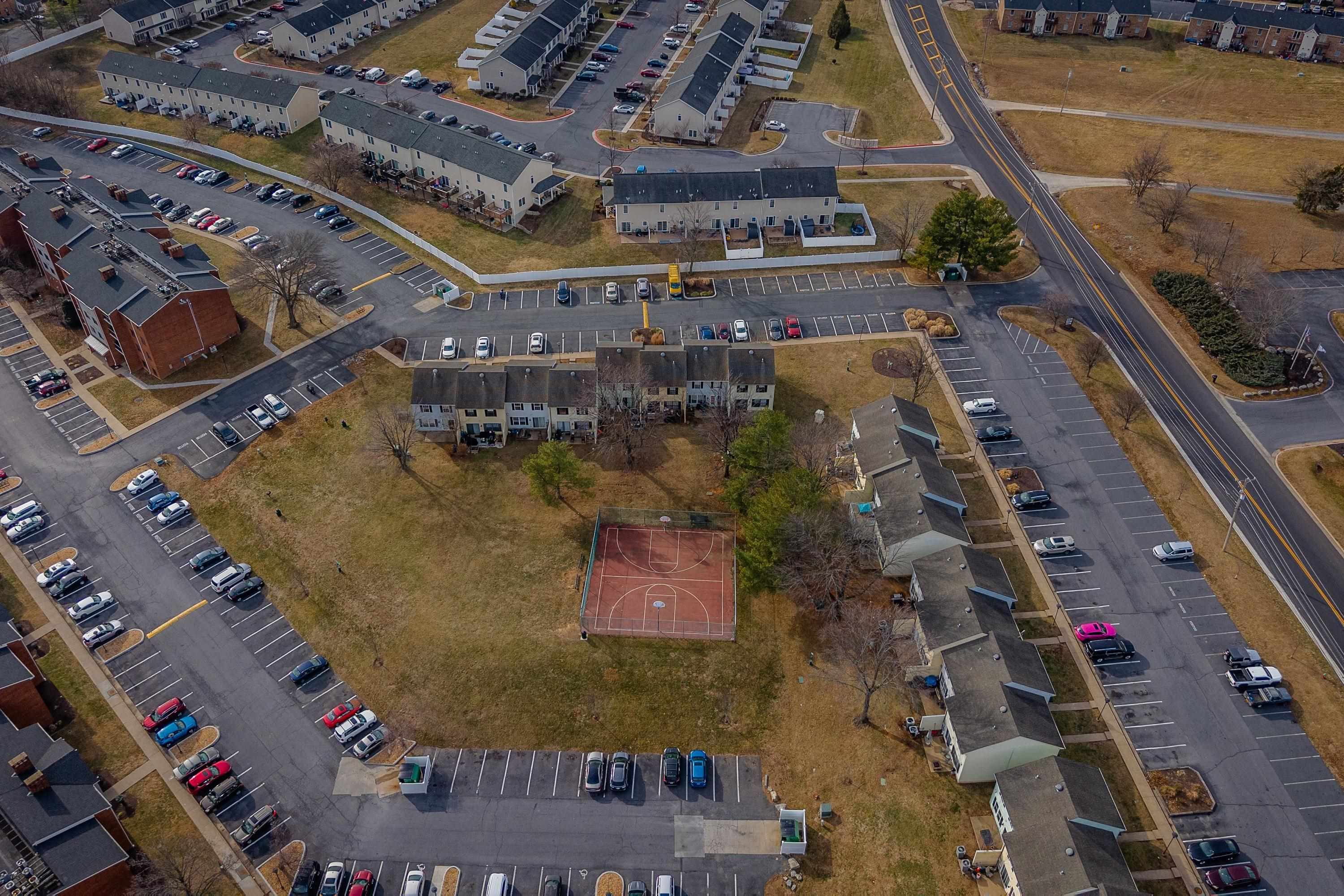 1211 Old Furnace Road Harrisonburg, VA 22802 - Photo 43 of 55 The aerial photo highlights the townhouse location within the Madison Manor neighborhood, the abundance of parking spaces, and the convenient location within the city of Harrisonburg.