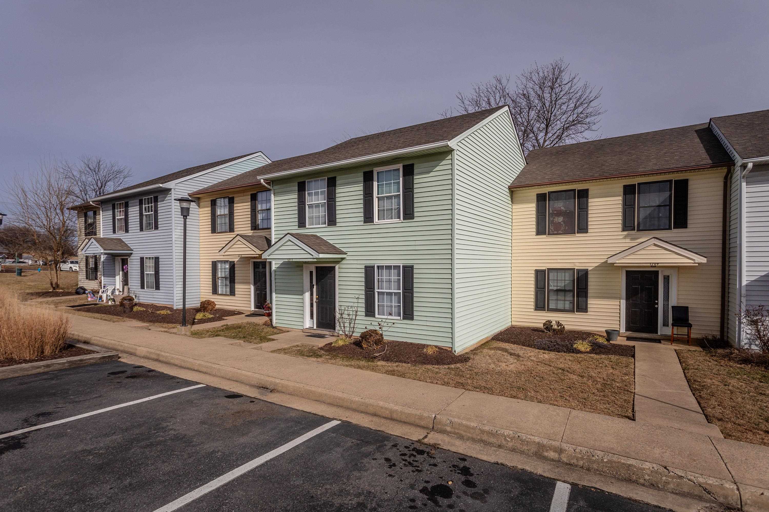 1211 Old Furnace Road Harrisonburg, VA 22802 - Photo 46 of 55 The front view of the townhouse highlights the sidewalks, multiple parking spaces, covered front porch space, and landscaping.