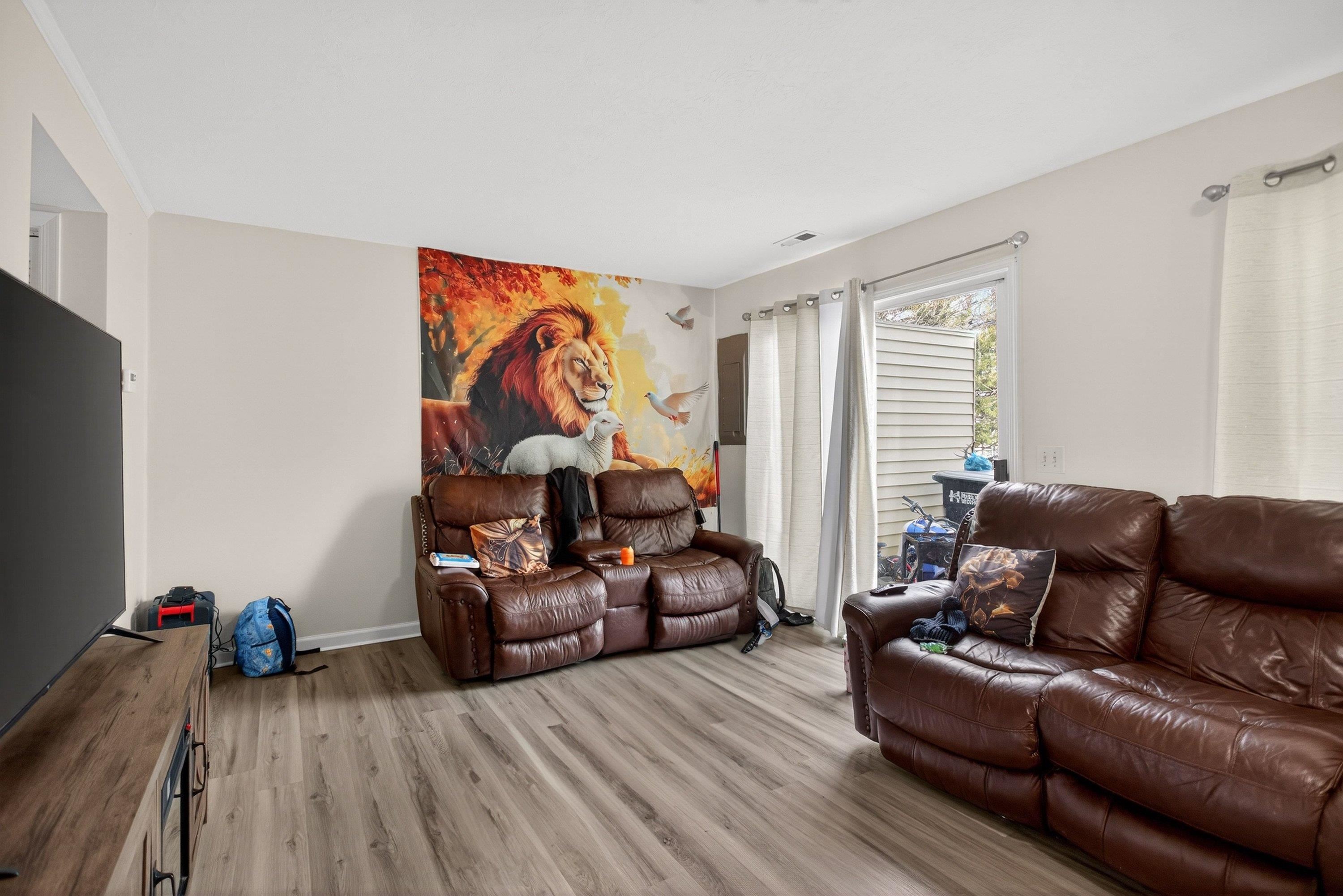 1211 Old Furnace Road Harrisonburg, VA 22802 - Photo 9 of 55 The very large living room offers an expansive area featuring luxury vinyl plank flooring and large patio doors leading to the rear of the home. This living room space opens up to the kitchen and dining area.