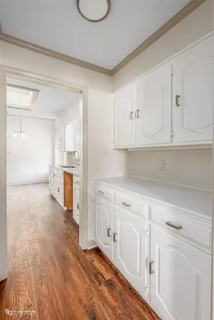 a kitchen with granite countertop a sink cabinets and stainless steel appliances