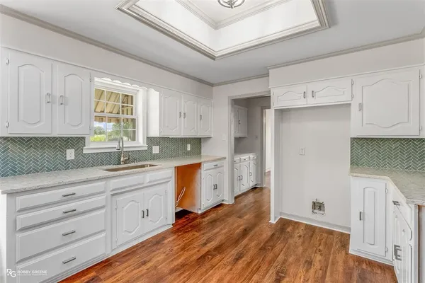 a kitchen with granite countertop white cabinets and white appliances