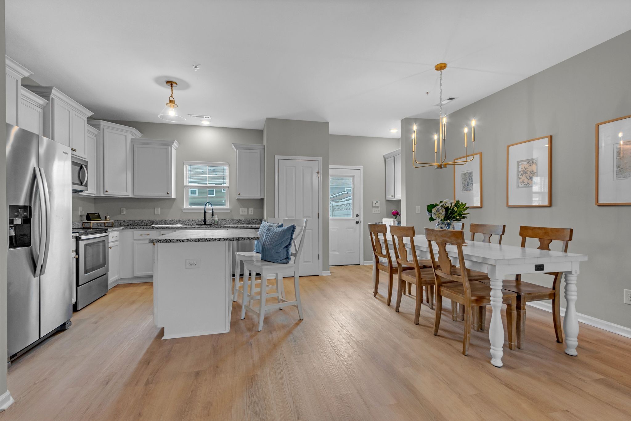 307 Oldbury Lane Spring Hill, TN 37174 - Photo 8 of 23 a kitchen with a dining table chairs refrigerator and cabinets