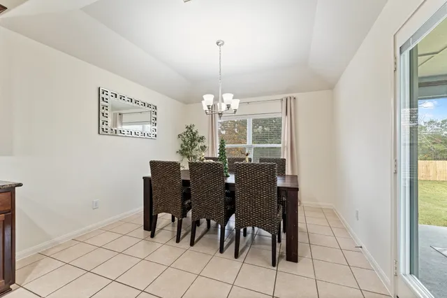 a view of a dining room with furniture and window