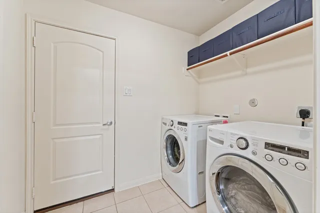 a view of washer and dryer with kitchen in the background