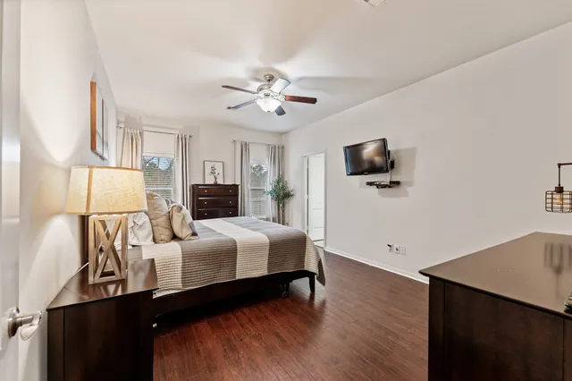 a bedroom with furniture and a flat screen tv