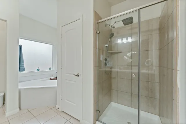 a bathroom with a shower and a sink