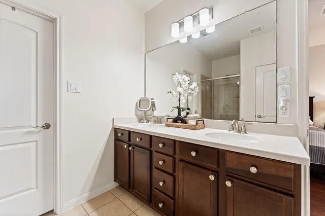 a bathroom with a double vanity sink and a mirror