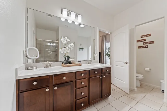 a bathroom with a double vanity sink and a mirror