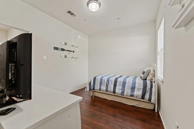 a view of bedroom with furniture and wooden floor