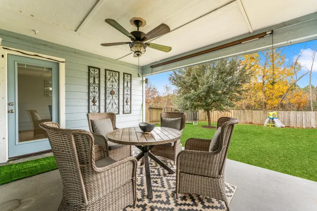a view of a porch with furniture and a yard