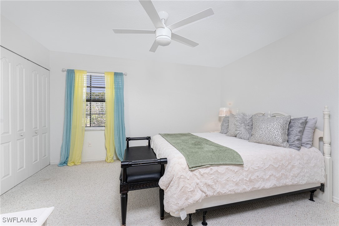 13100 South McCall Road, Unit 112 Port Charlotte, FL 33981 - Photo 15 of 45 a bedroom with a bed and a ceiling fan