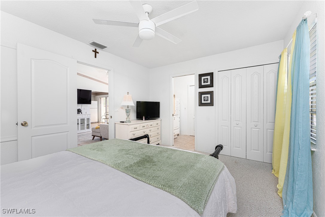 13100 South McCall Road, Unit 112 Port Charlotte, FL 33981 - Photo 16 of 45 a bedroom with a bed and a flat screen tv