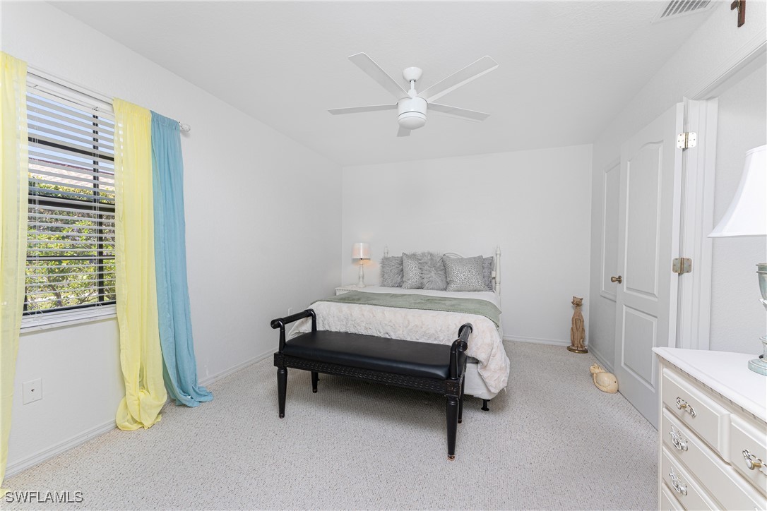 13100 South McCall Road, Unit 112 Port Charlotte, FL 33981 - Photo 17 of 45 a bedroom with a bed and a chandelier