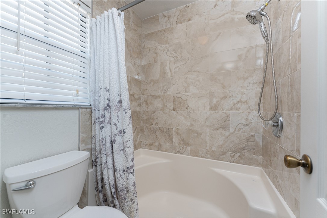 13100 South McCall Road, Unit 112 Port Charlotte, FL 33981 - Photo 20 of 45 a bathroom with a toilet and a bathtub
