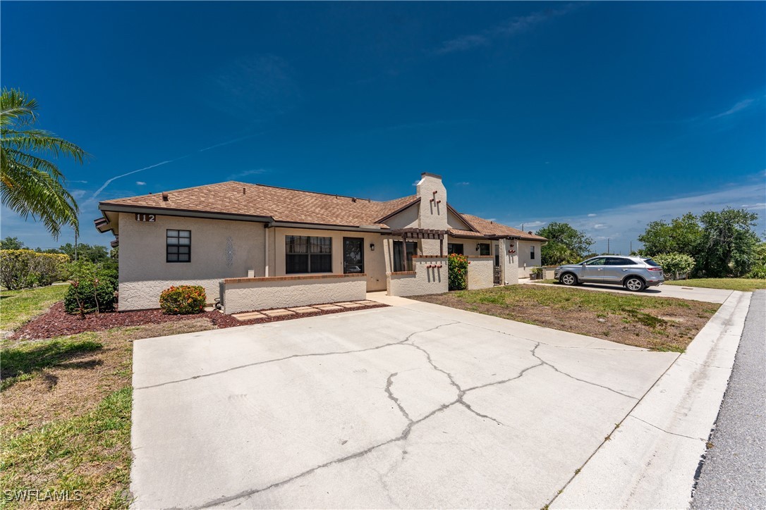 13100 South McCall Road, Unit 112 Port Charlotte, FL 33981 - Photo 2 of 45 a view of house with yard outdoor seating and entertaining space