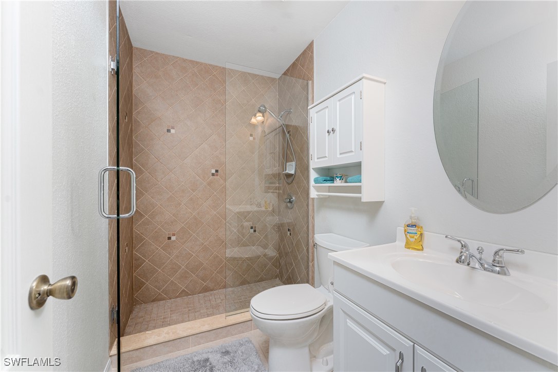 13100 South McCall Road, Unit 112 Port Charlotte, FL 33981 - Photo 23 of 45 a bathroom with a sink toilet and shower