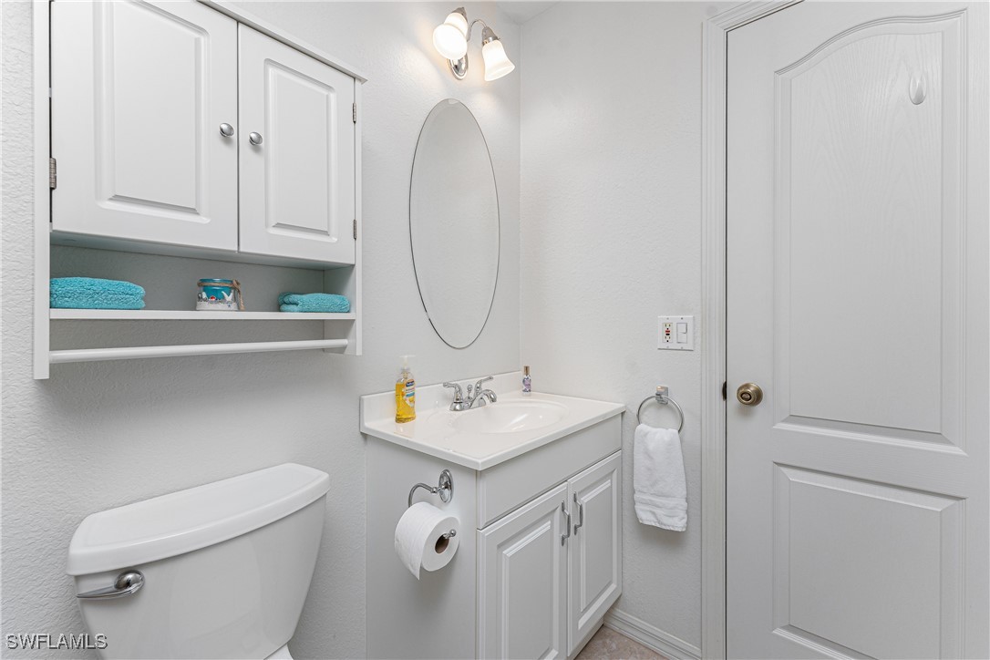 13100 South McCall Road, Unit 112 Port Charlotte, FL 33981 - Photo 24 of 45 a bathroom with a sink a toilet and a mirror
