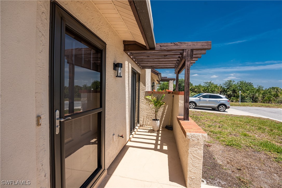 13100 South McCall Road, Unit 112 Port Charlotte, FL 33981 - Photo 27 of 45 a view of a patio with a table and chairs