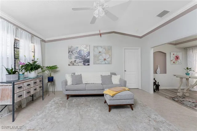 a living room with furniture and flowers