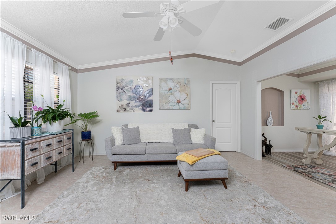 13100 South McCall Road, Unit 112 Port Charlotte, FL 33981 - Photo 3 of 45 a living room with furniture and flowers