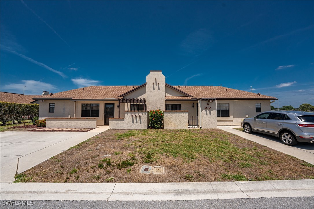 13100 South McCall Road, Unit 112 Port Charlotte, FL 33981 - Photo 38 of 45 a view of a white house in front of a yard