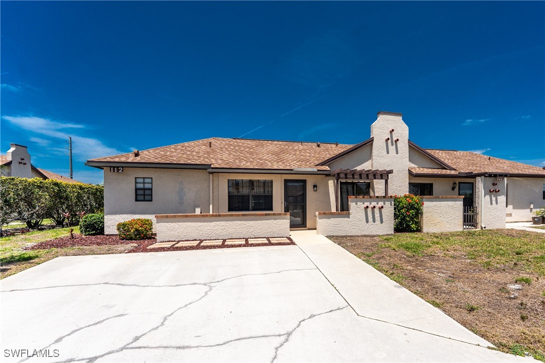13100 South McCall Road, Unit 112 Port Charlotte, FL 33981 - Photo 45 of 45 a front view of a house with a yard