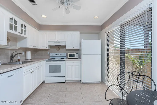 a kitchen with a refrigerator and a sink