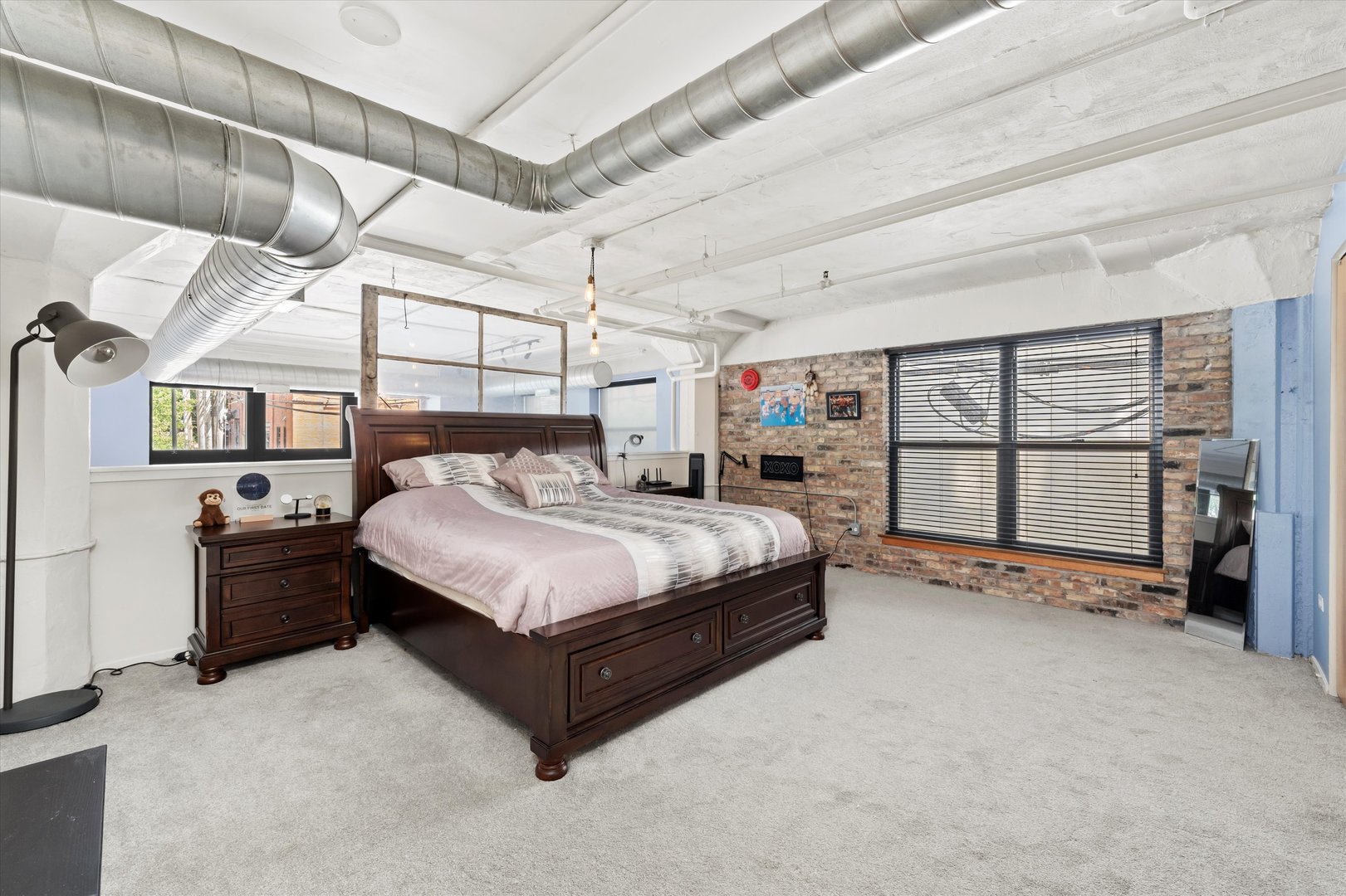 1601 South Michigan Avenue, Unit 108 Chicago, IL 60616 - Photo 13 of 36 a large bed sitting in a room next to a window