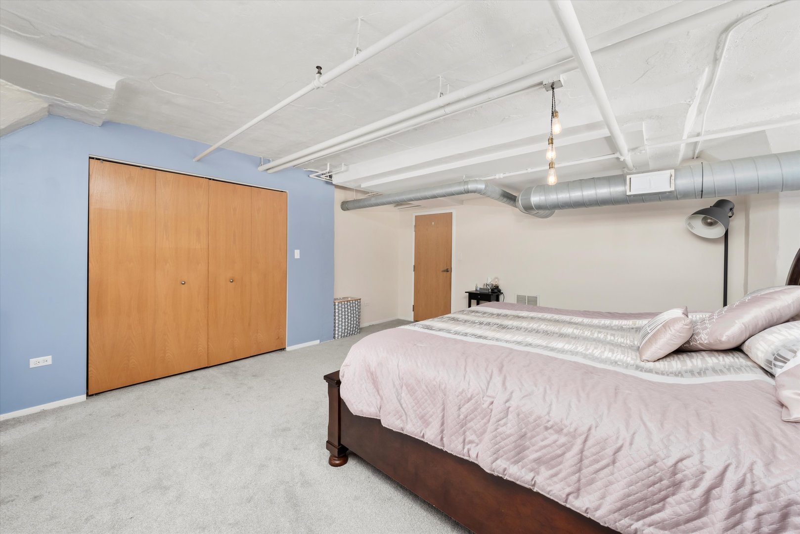 1601 South Michigan Avenue, Unit 108 Chicago, IL 60616 - Photo 15 of 36 a bedroom with a bed and cabinets