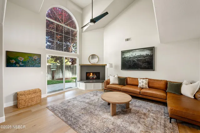 a living room with furniture a fireplace and a flat screen tv
