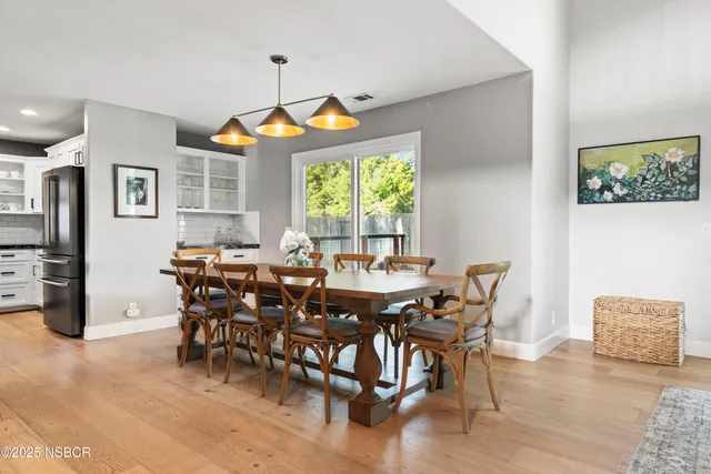 a dining room with furniture a rug and a chandelier