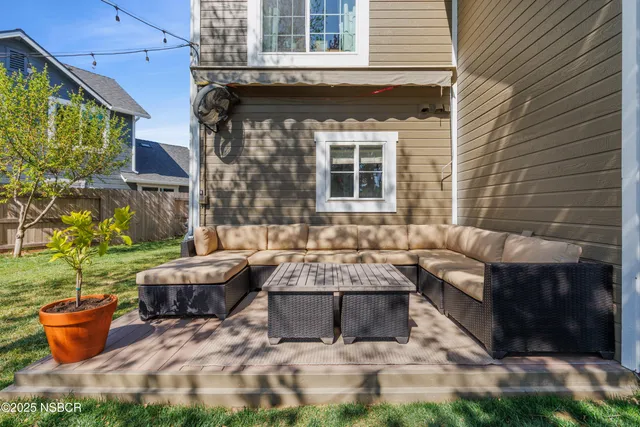 a building outdoor space with patio furniture and potted plants