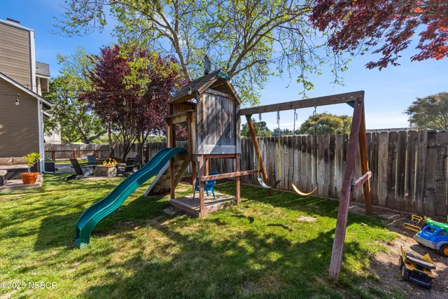 a view of a backyard with a house and wooden deck