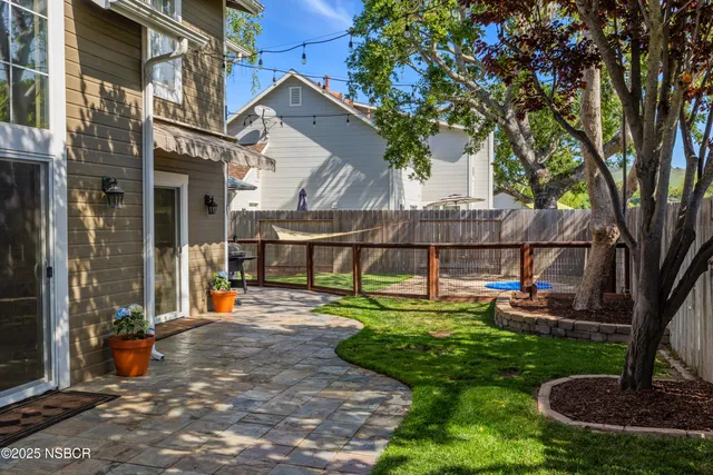a view of a house with backyard and sitting area
