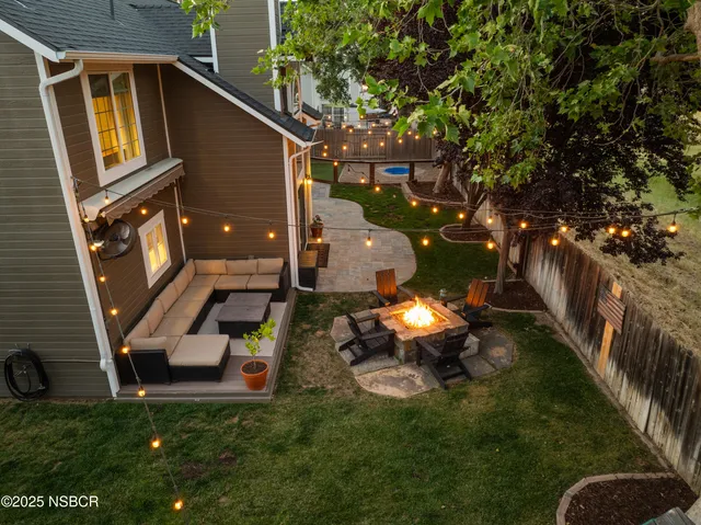 a backyard of a house with table and chairs