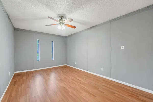 a view of empty room with wooden floor