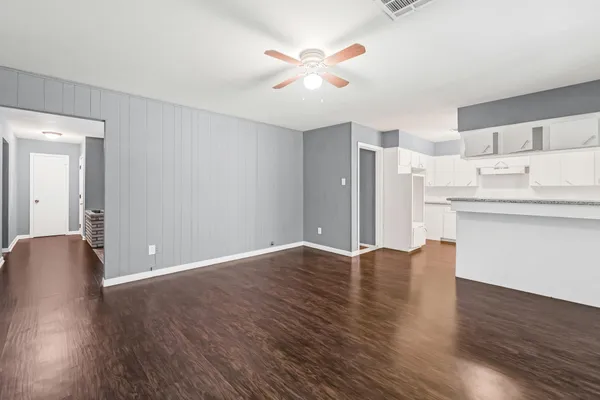 a view of kitchen with granite countertop cabinets and wooden floor