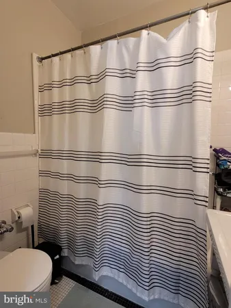 a bathroom with a shower and a sink