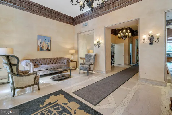 a living room with furniture and a chandelier