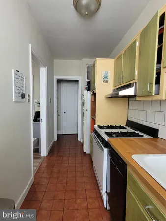 a kitchen with a stove and a refrigerator