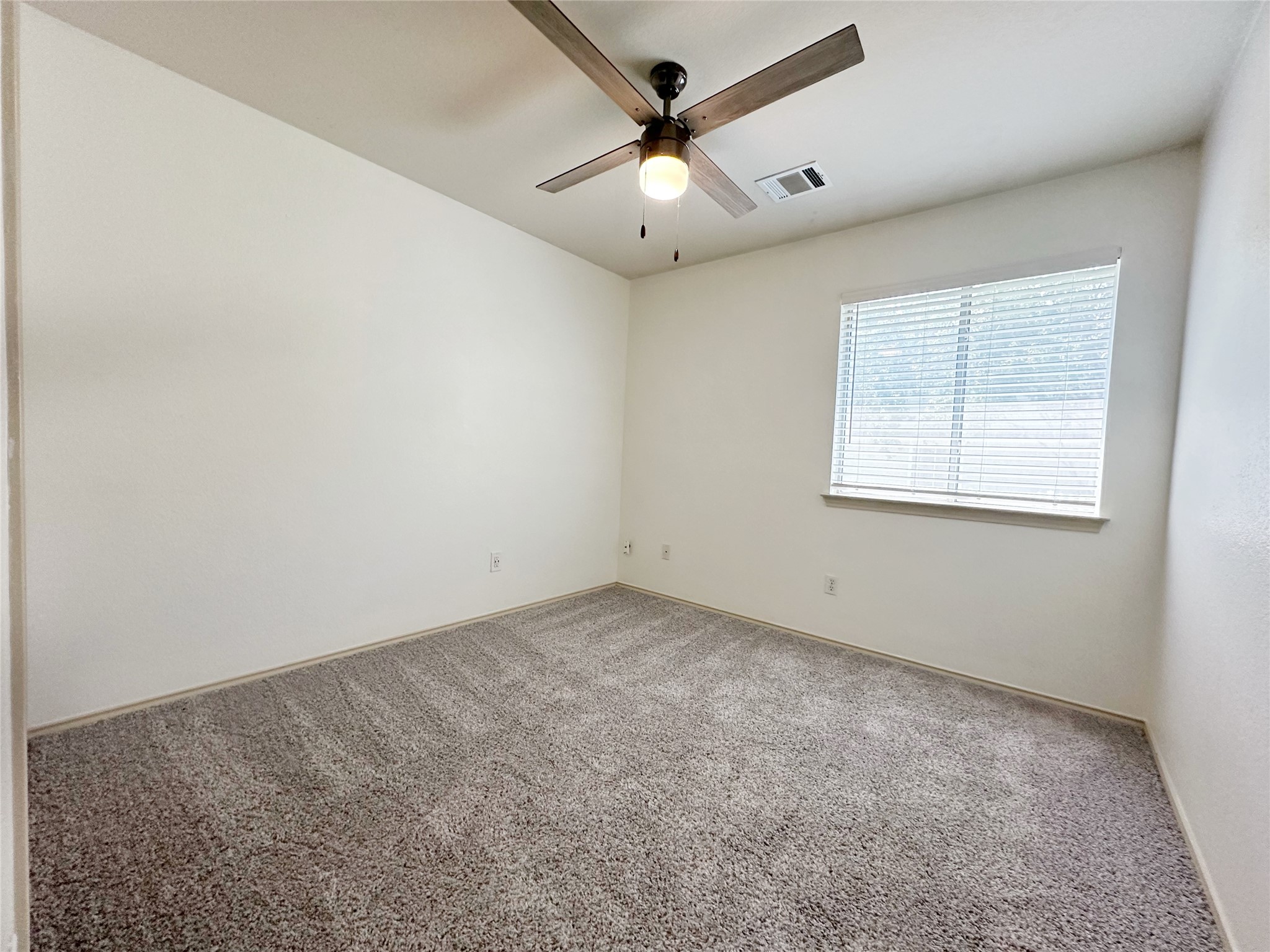 4500 Mather Kyle, TX 78640 - Photo 12 of 14 an empty room with a window and a fan