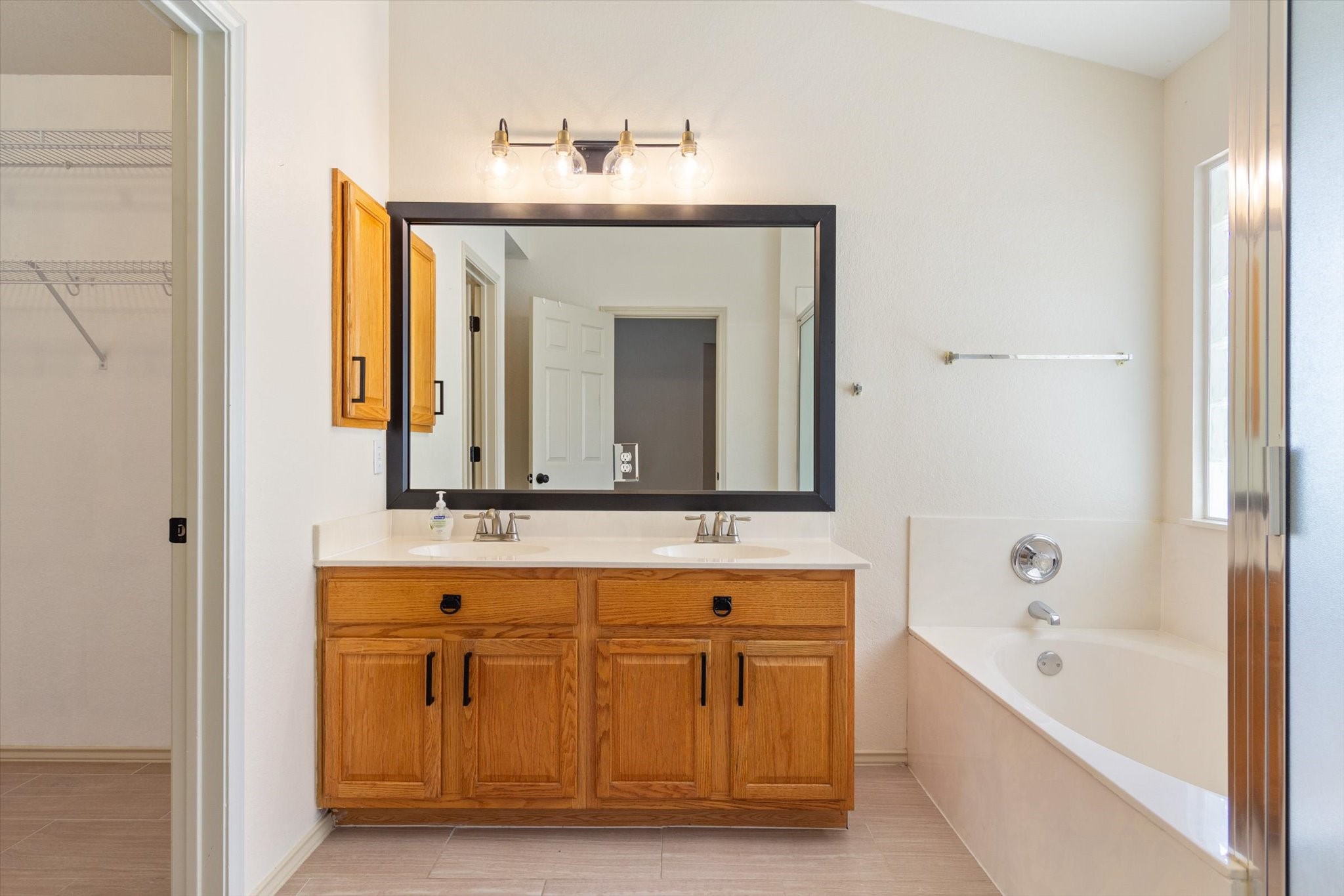 4500 Mather Kyle, TX 78640 - Photo 6 of 14 a bathroom with a bathtub sink and mirror