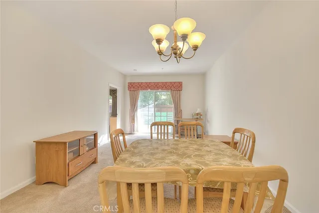 a dining room with furniture and chandelier