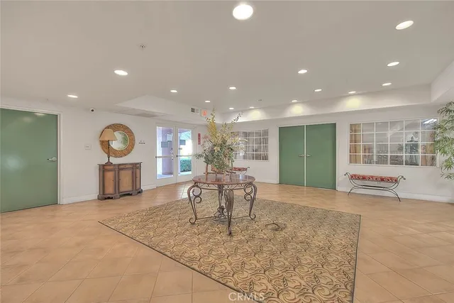 a living room with furniture a large window and kitchen view