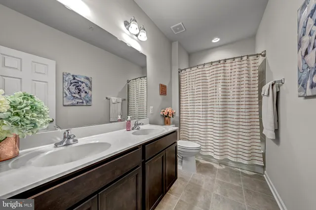 a bathroom with a sink double vanity and a shower
