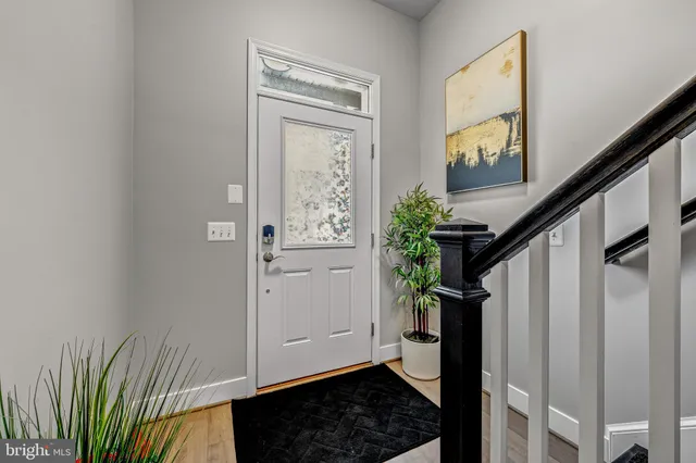a view of entryway with wooden floor and stairs