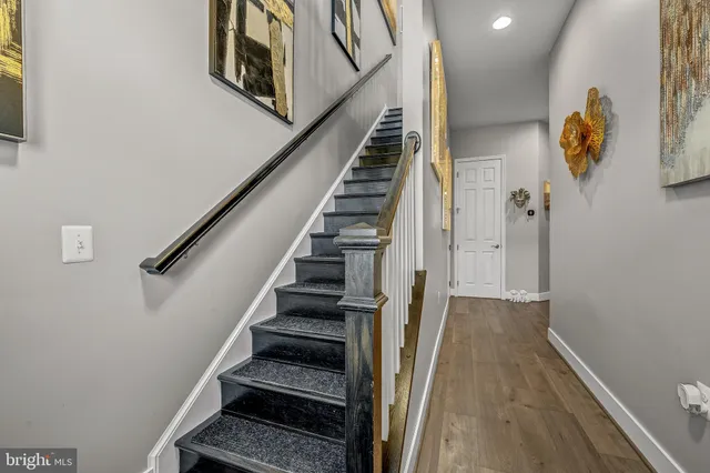 a view of entryway and hall with wooden floor